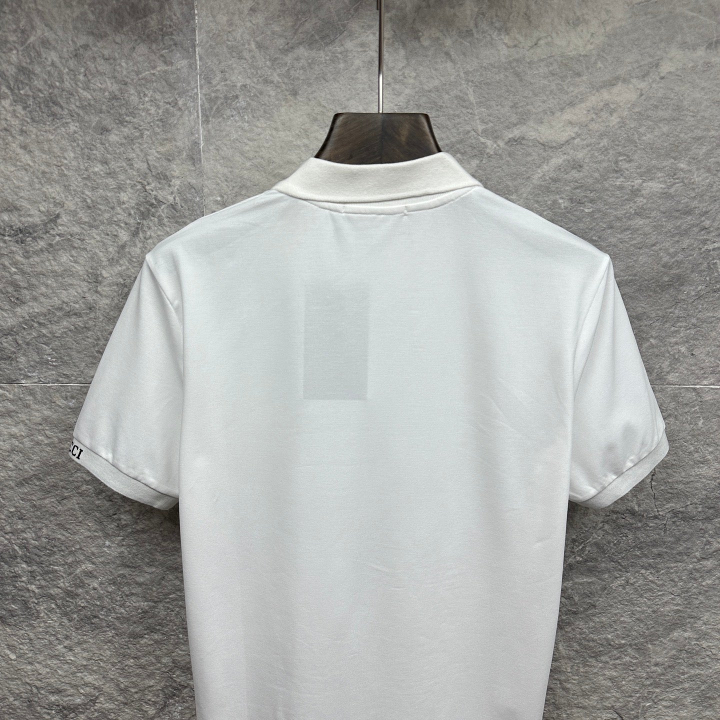 White Gucci polo shirt back view with ribbed collar and short sleeves
