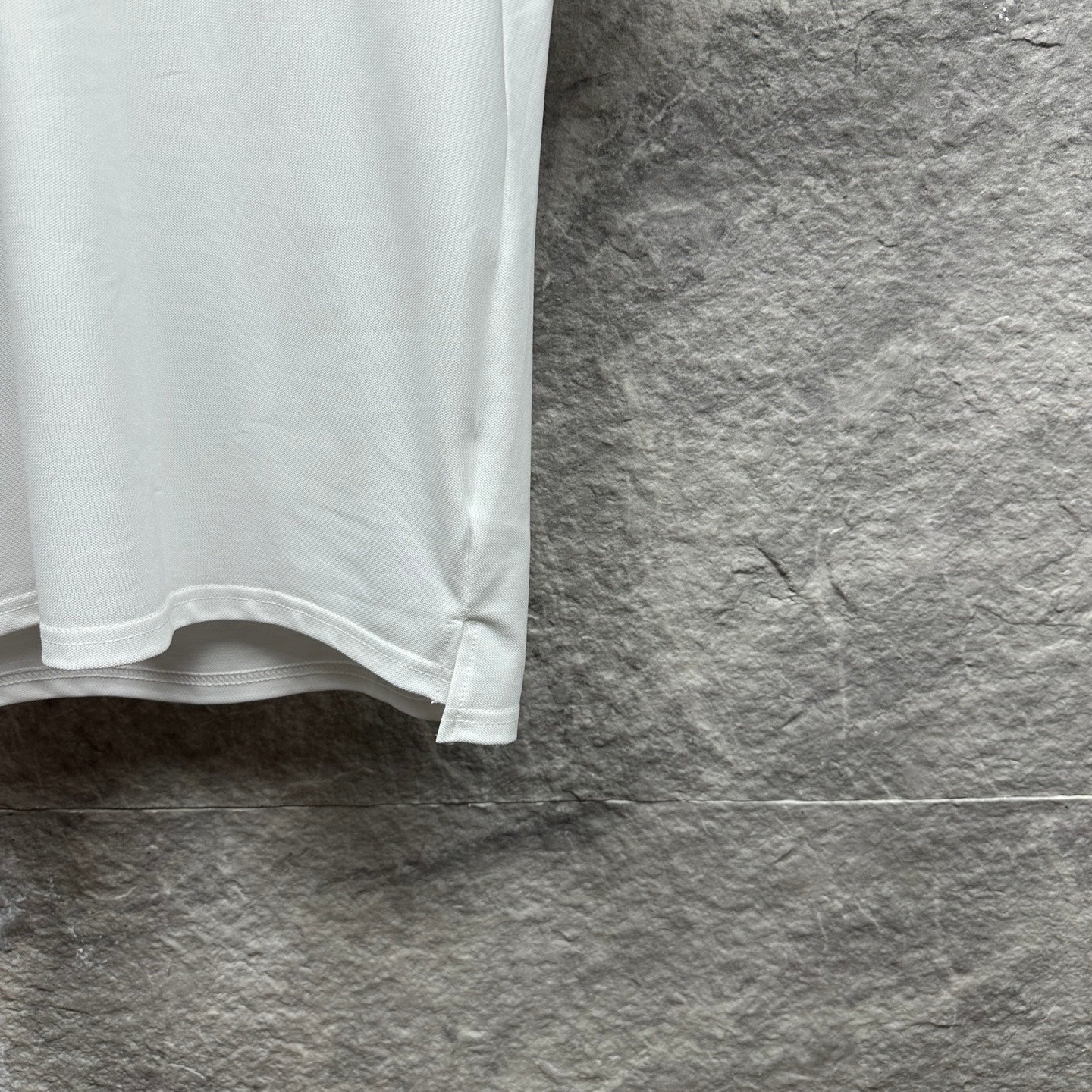 White Gucci polo shirt lower hem detail with stitched edge