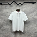 White Gucci polo shirt with button placket and embroidered logo on sleeve