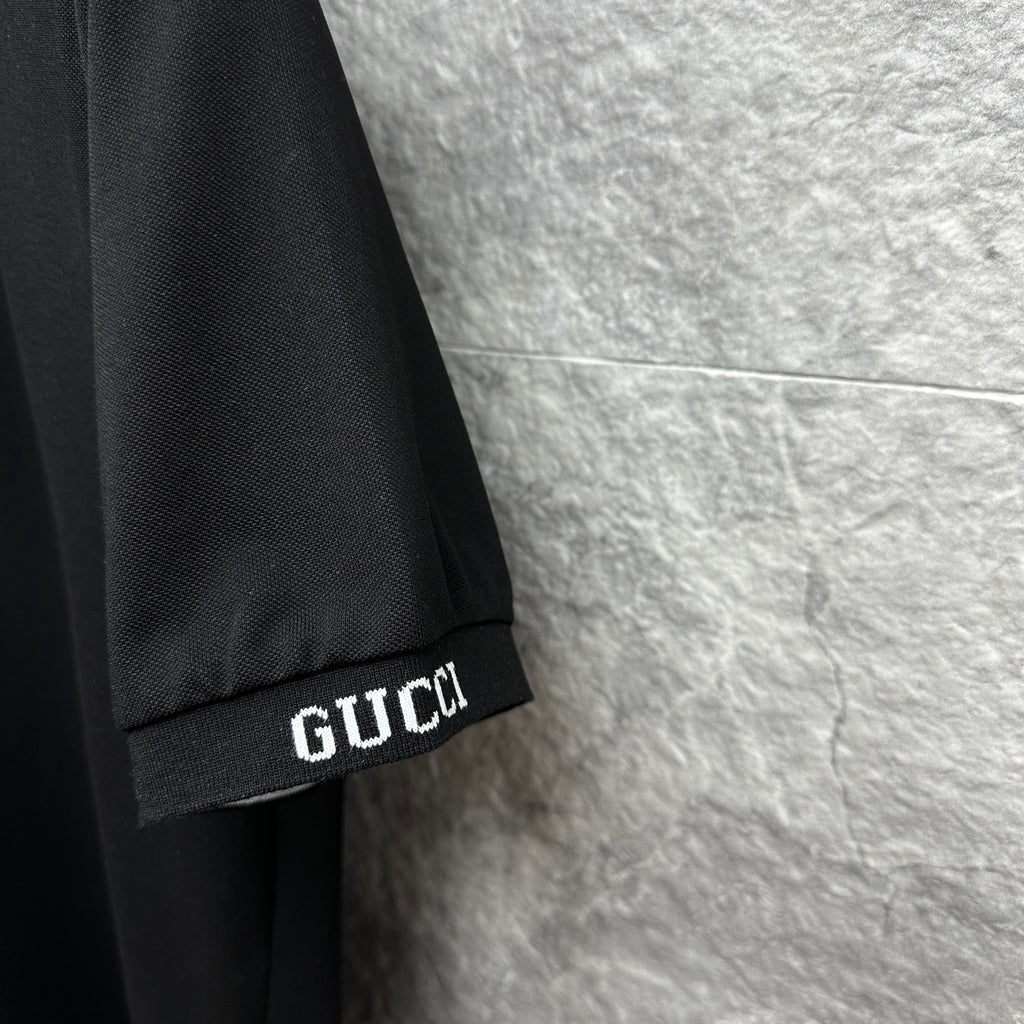 Black Gucci polo shirt sleeve cuff with GUCCI logo detail