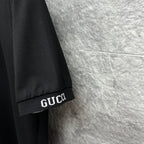 Black Gucci polo shirt sleeve cuff with GUCCI logo detail