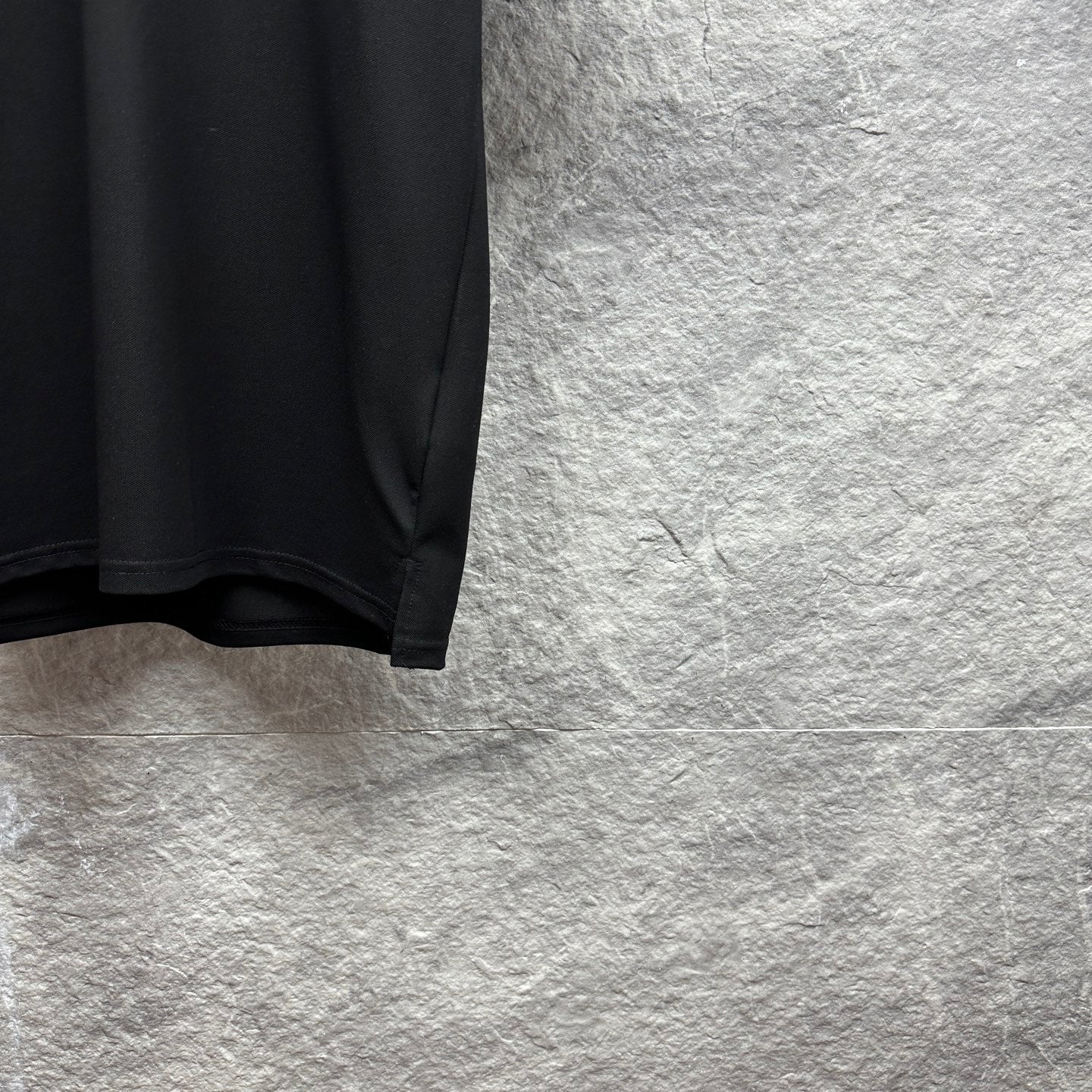 Black Gucci polo shirt lower side seam and curved hem
