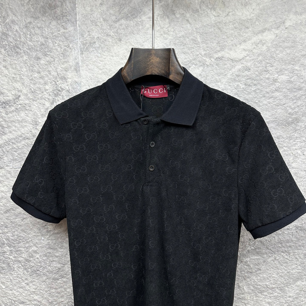 Black Gucci polo shirt with collar and buttons, short sleeves, subtle GG monogram.