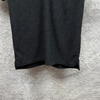 Black Gucci polo shirt, front bottom hem and side seam, GG monogram pattern.