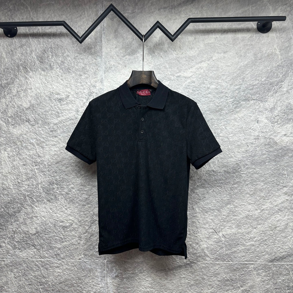 Black Gucci polo shirt, short sleeves, button placket, GG monogram pattern.