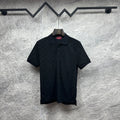 Black Gucci polo shirt, short sleeves, button placket, GG monogram pattern.