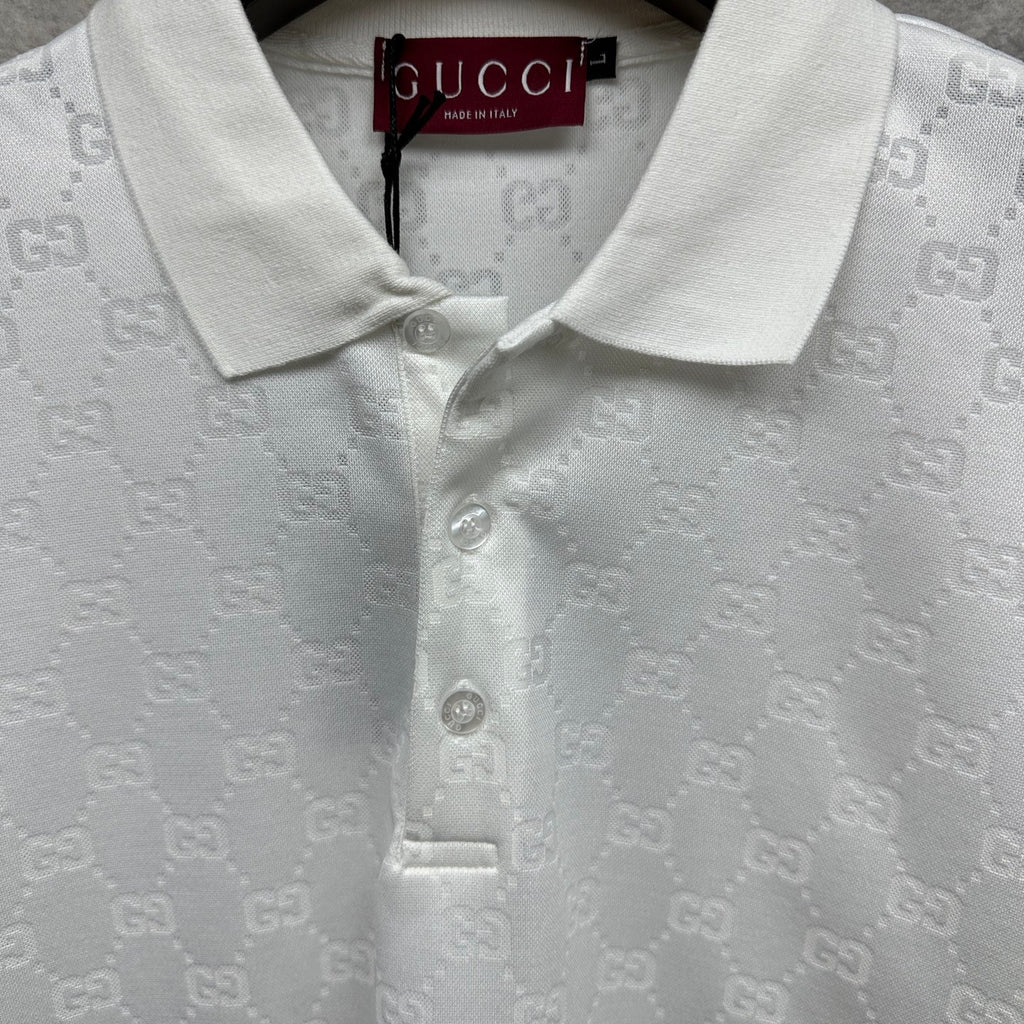 White Gucci polo shirt neckline close-up with GG pattern and buttoned collar