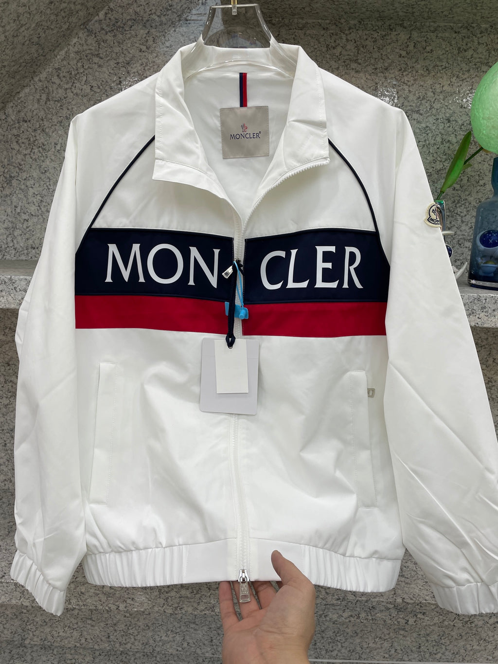 Moncler jacket front, white with navy/red logo stripe and zip front