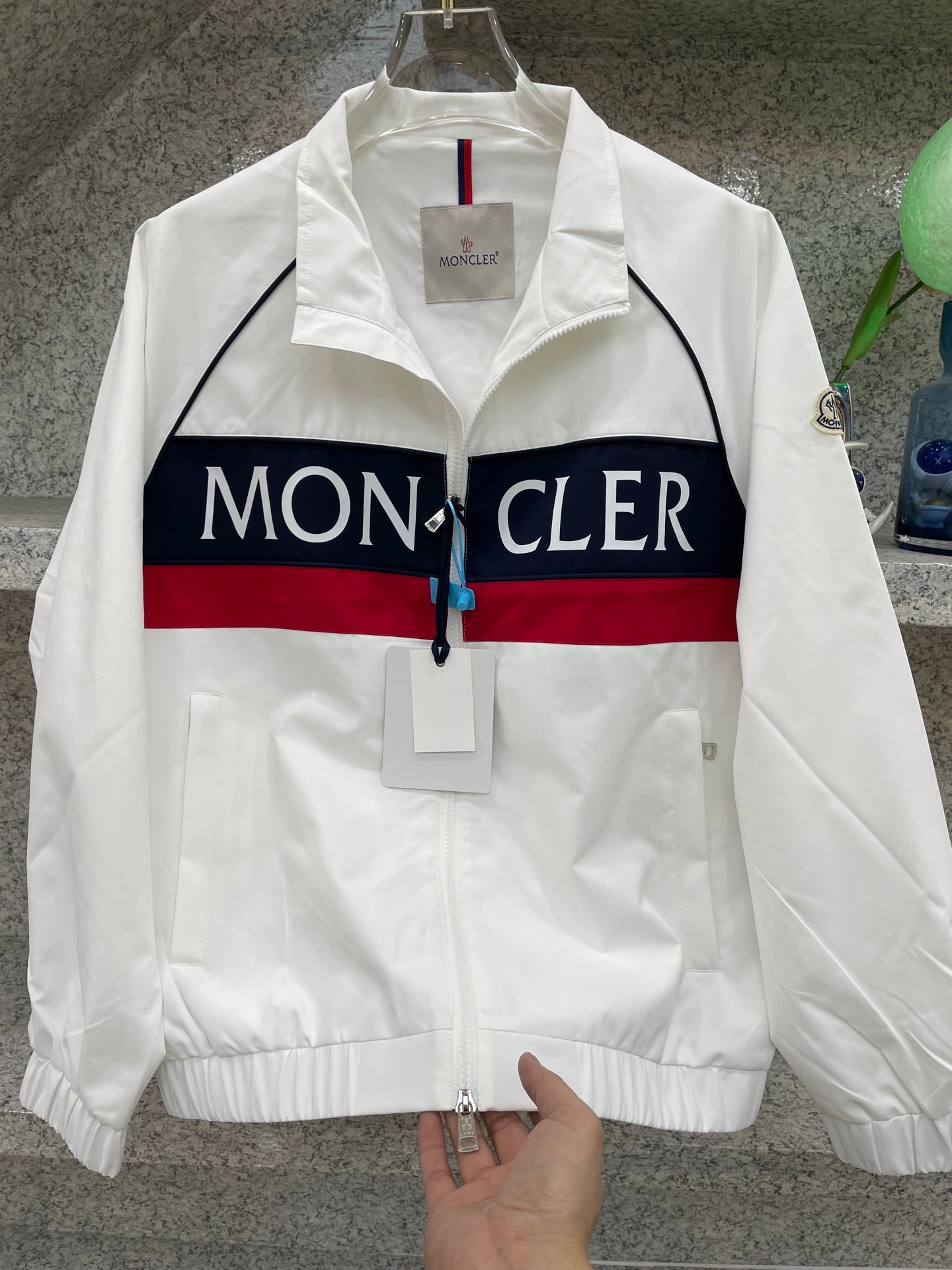 Moncler jacket front, white with navy/red logo stripe and zip front
