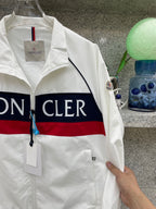 Moncler jacket side, white with navy/red logo stripe and sleeve patch