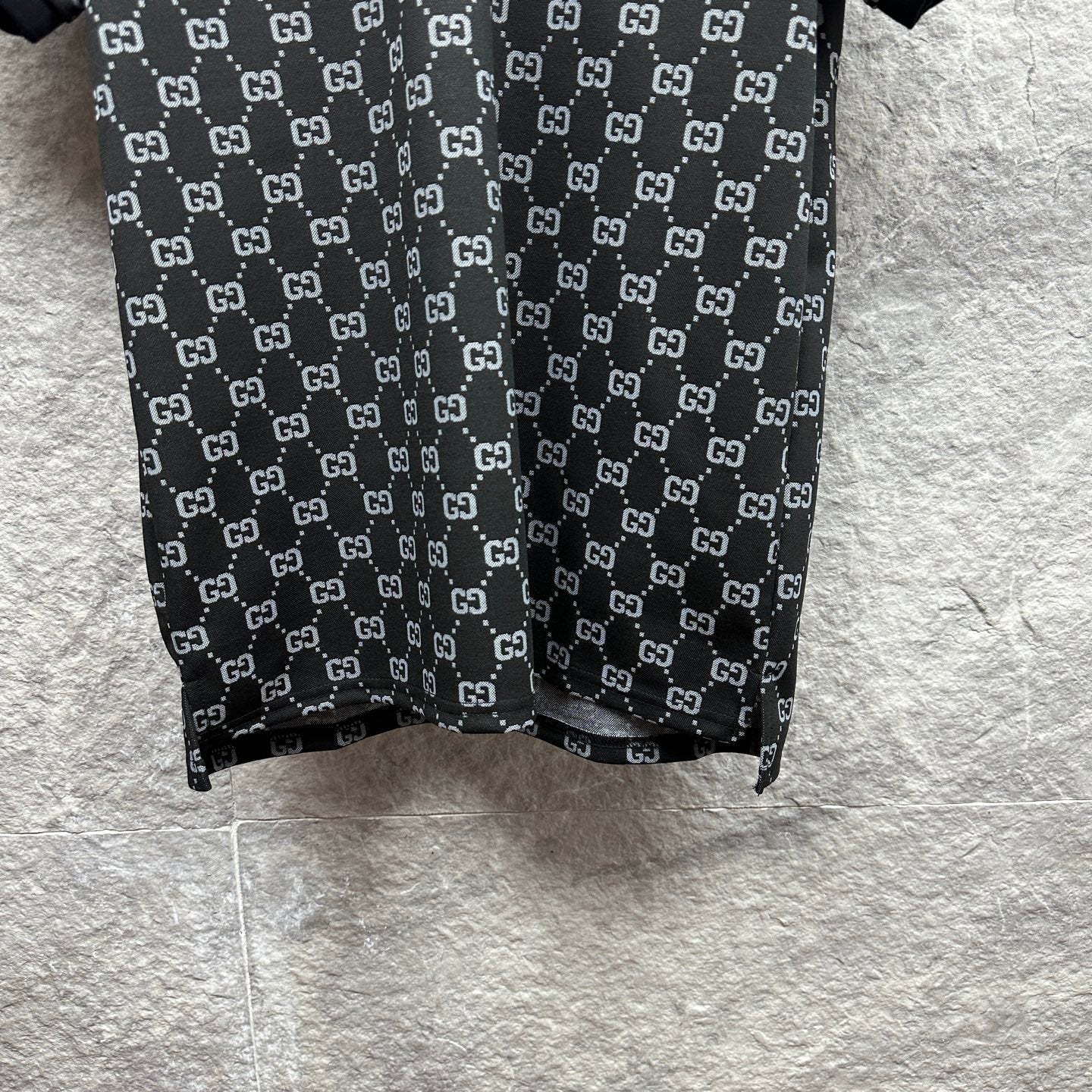 Gucci polo shirt hem view, dark navy GG pattern with straight bottom