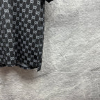 Gucci polo shirt side view, dark navy GG pattern with ribbed sleeve hem