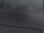 Louis Vuitton bag close-up of engraved “LOUIS VUITTON PARIS” logo on leather trim