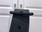 Louis Vuitton bag close-up of top loop hardware and dark leather strap