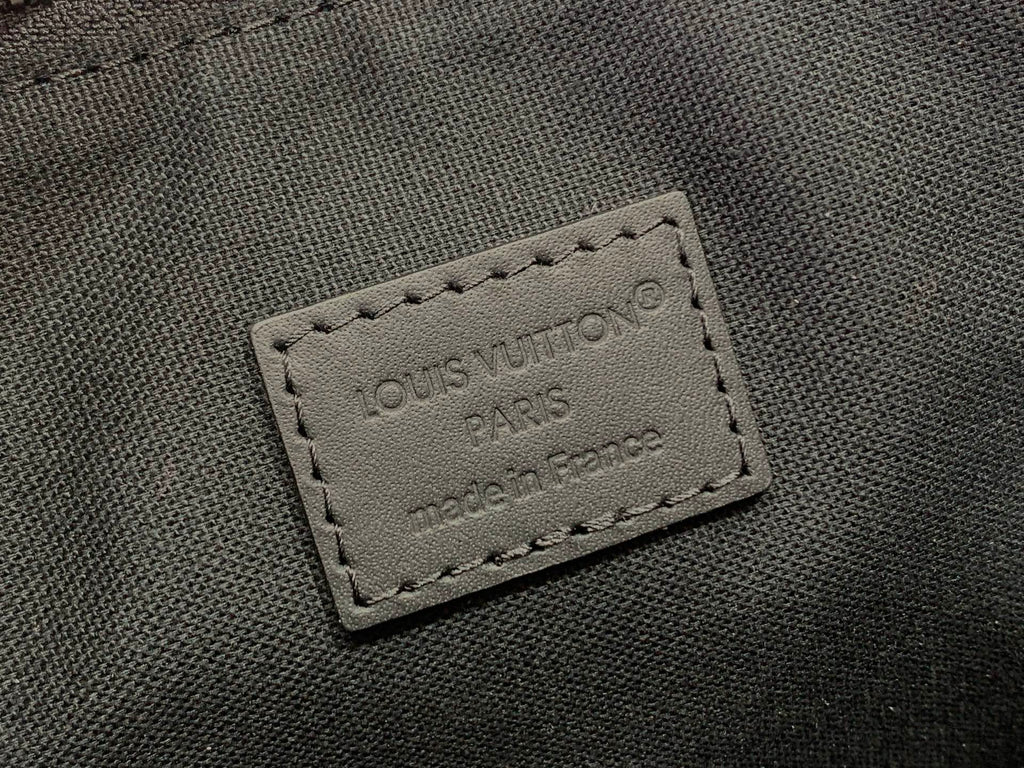 Louis Vuitton bag close-up of stitched leather patch with “LOUIS VUITTON PARIS”
