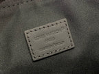 Louis Vuitton bag close-up of stitched leather patch with “LOUIS VUITTON PARIS”