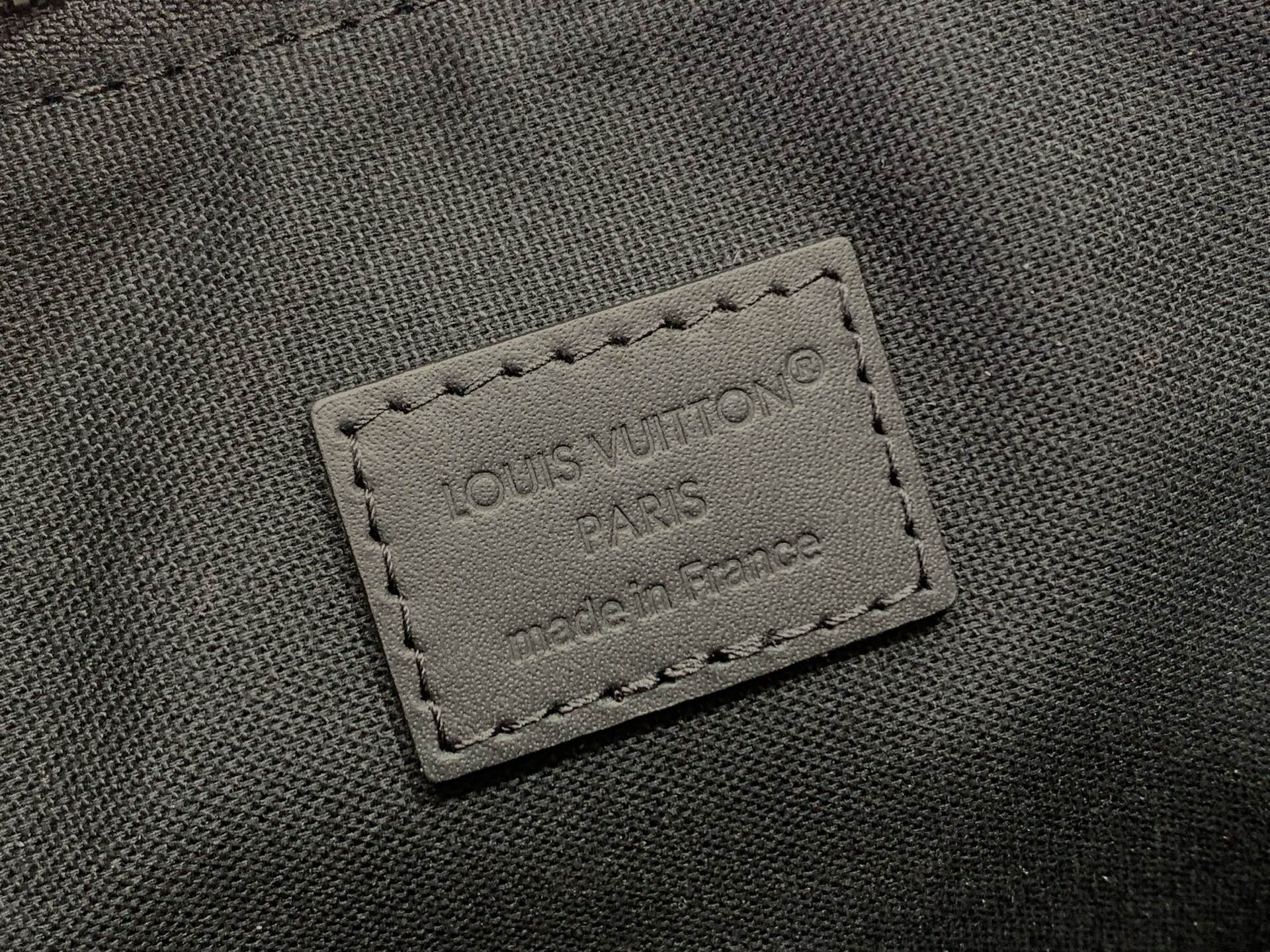 Louis Vuitton bag close-up of stitched leather patch with “LOUIS VUITTON PARIS”