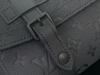 Louis Vuitton bag close-up of strap hardware and dark monogram embossed leather