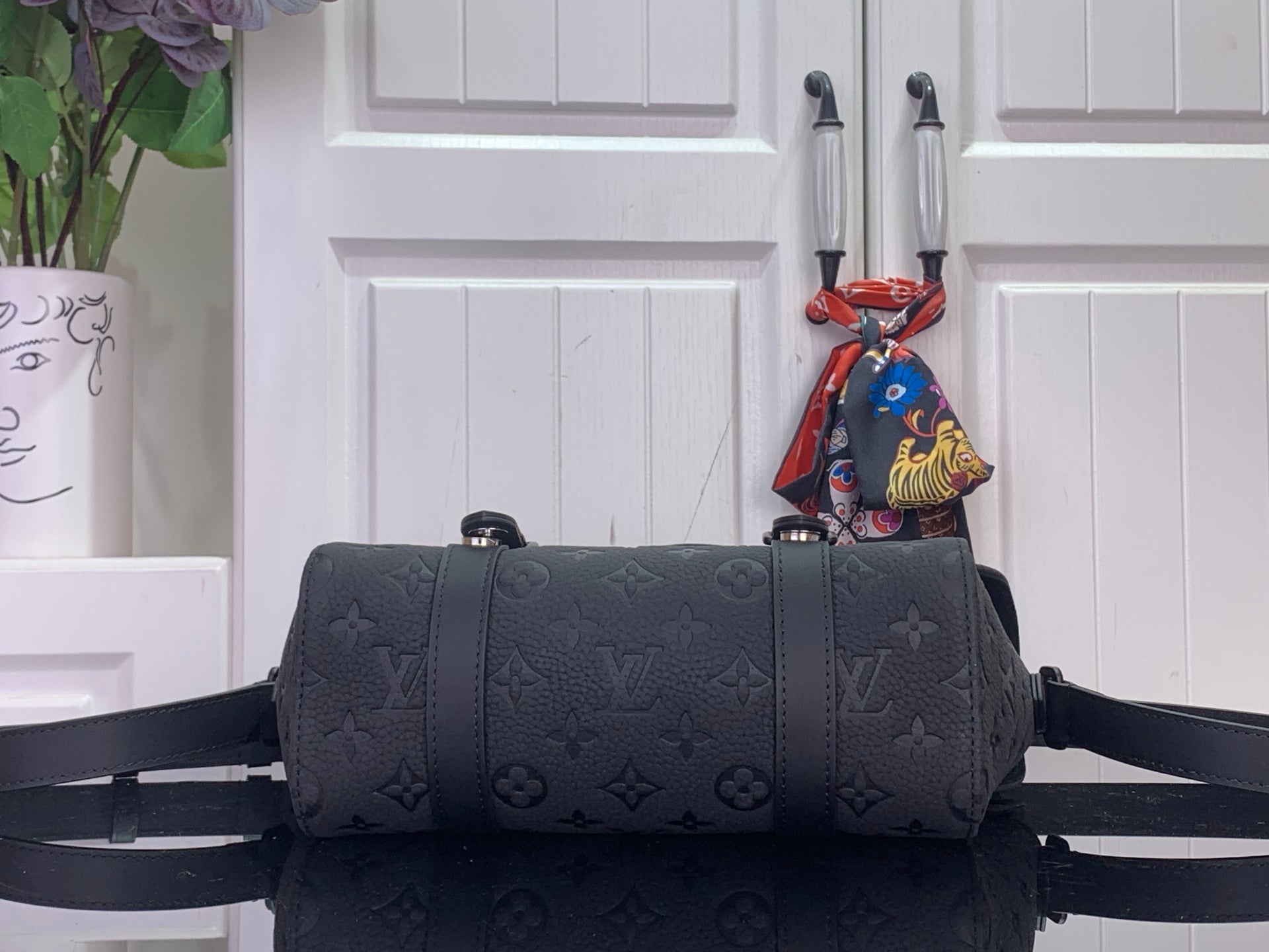 Louis Vuitton bag in dark monogram canvas, front view with crossbody strap