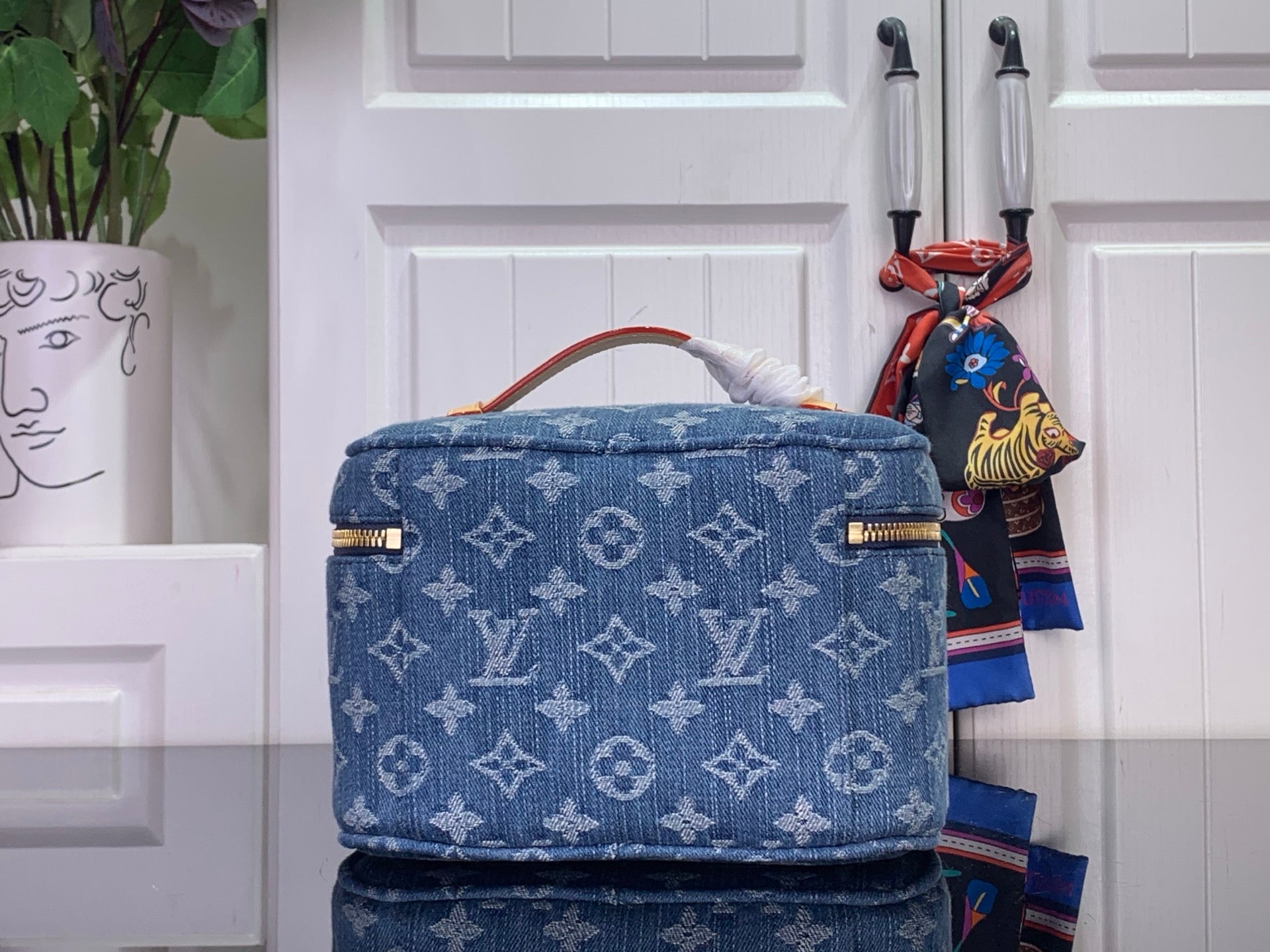 Louis Vuitton blue monogram canvas bag with gold trim and top handle