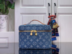 Louis Vuitton blue monogram vanity bag with top handle and gold hardware.