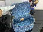 Louis Vuitton blue monogram bag open showing interior and tan leather patch