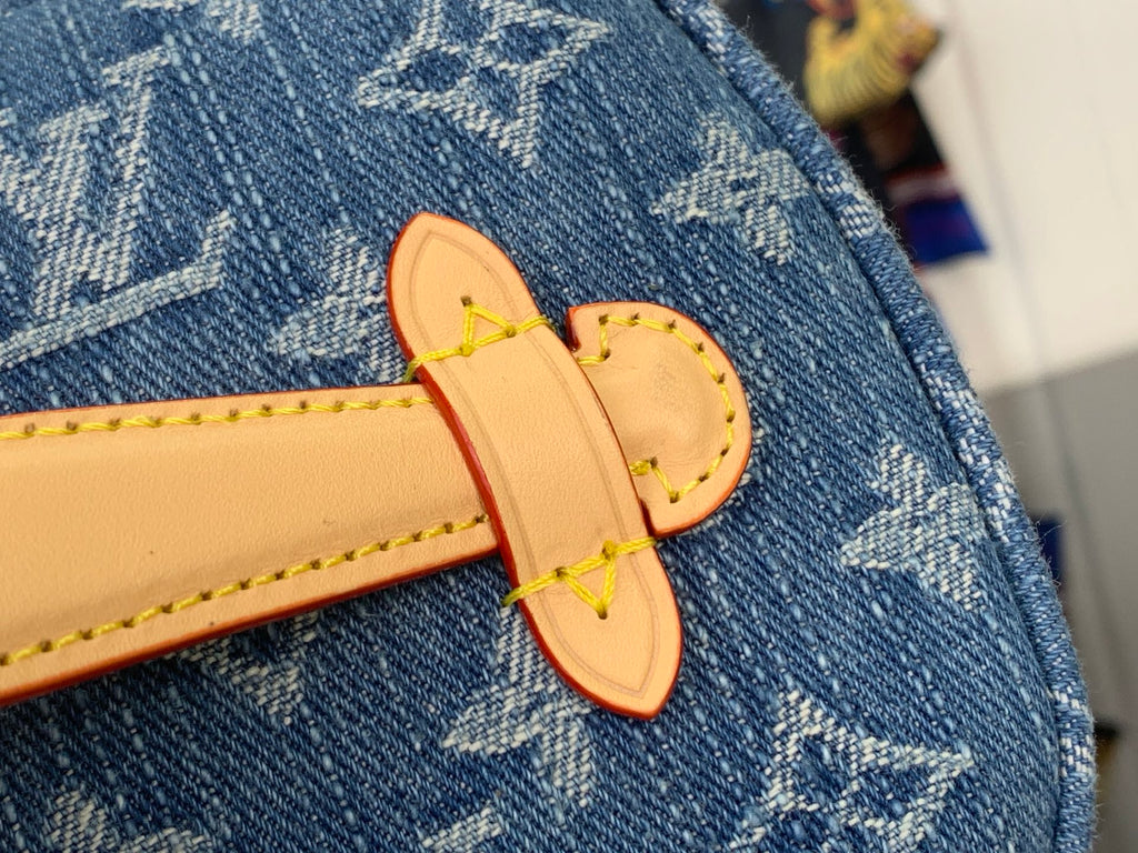 Louis Vuitton bag tan leather logo strap with gold buckle on blue monogram canvas