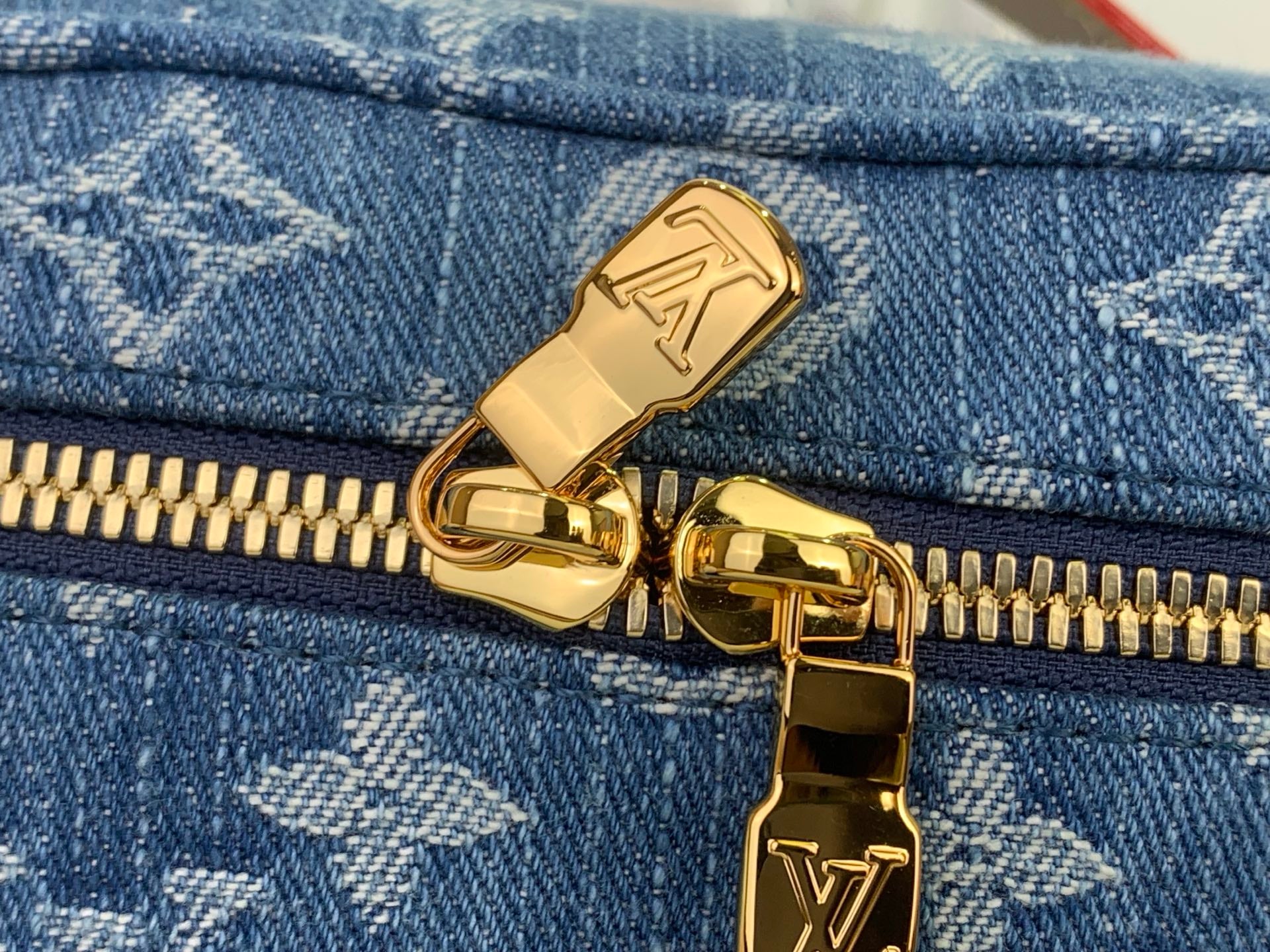 Louis Vuitton bag zipper pull and gold hardware on blue monogram canvas