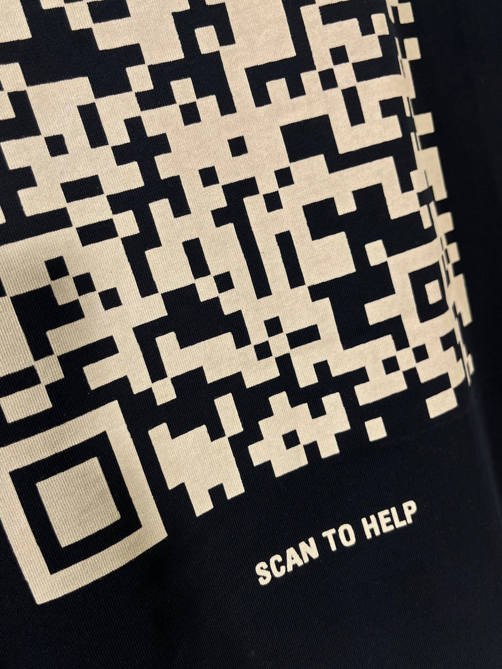 Balenciaga T-shirt close-up of pixel pattern with “SCAN TO HELP” text
