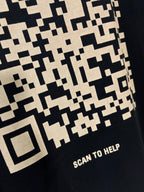 Balenciaga T-shirt close-up of pixel pattern with “SCAN TO HELP” text