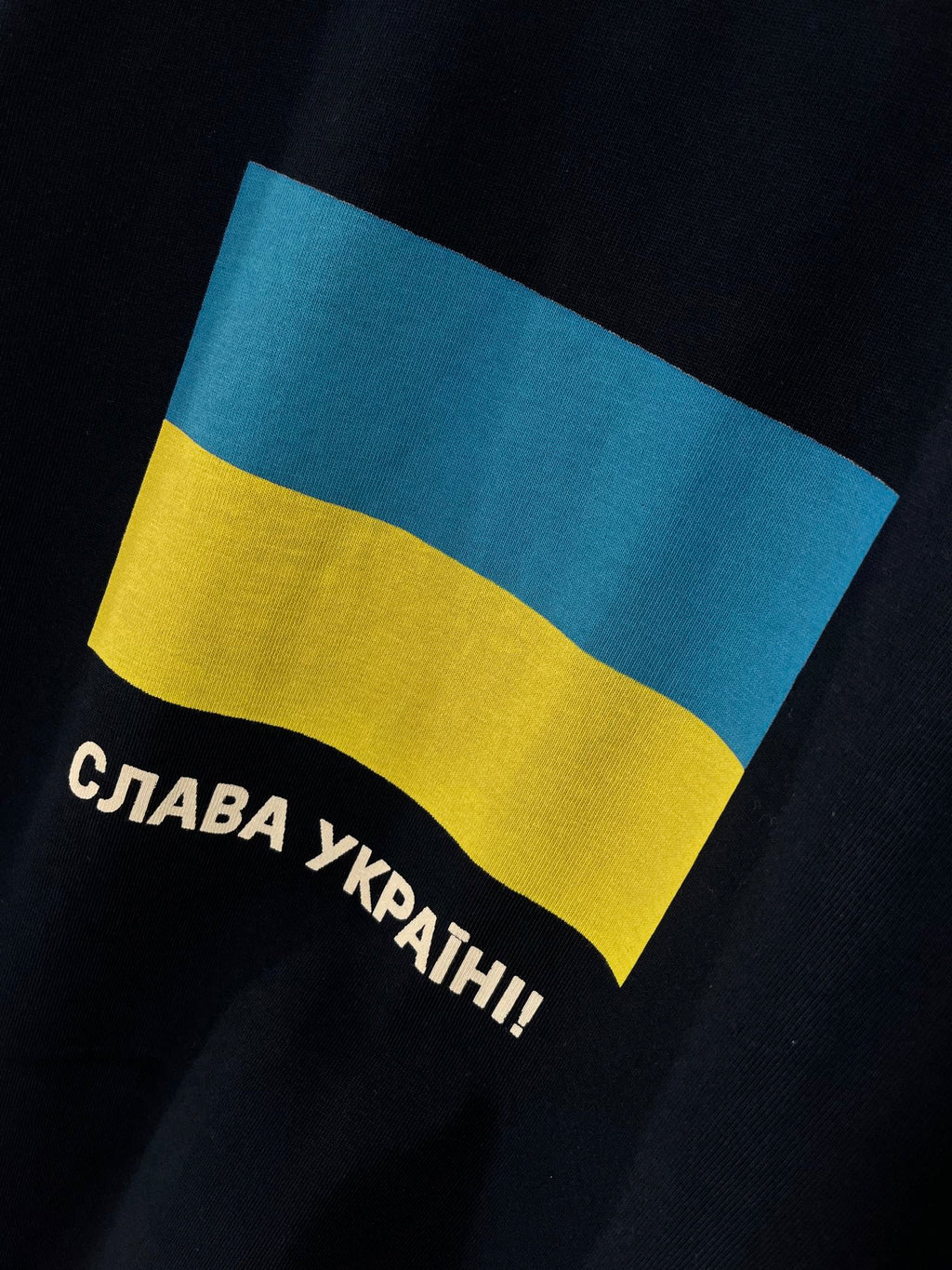 Balenciaga T-shirt close-up of blue-yellow flag graphic with Cyrillic slogan