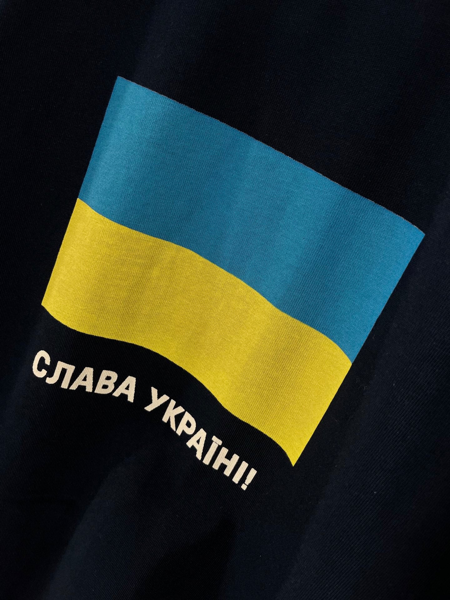 Balenciaga T-shirt close-up of blue-yellow flag graphic with Cyrillic slogan