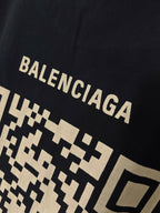 Balenciaga T-shirt close-up showing large “BALENCIAGA” lettering over pixel pattern
