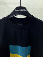 Balenciaga crew-neck T-shirt close-up with “BALENCIAGA” and blue-yellow flag print