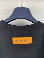 Louis Vuitton yellow logo tag on T-shirt collar, dark fabric