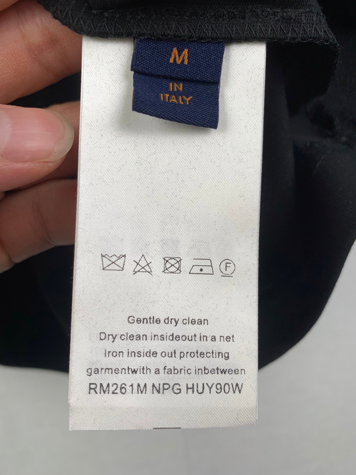 Louis Vuitton shorts care label with blue size tag M and Italy, dark fabric waistband