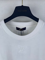 White T-shirt collar with blue inner tag and embossed LV monogram.
