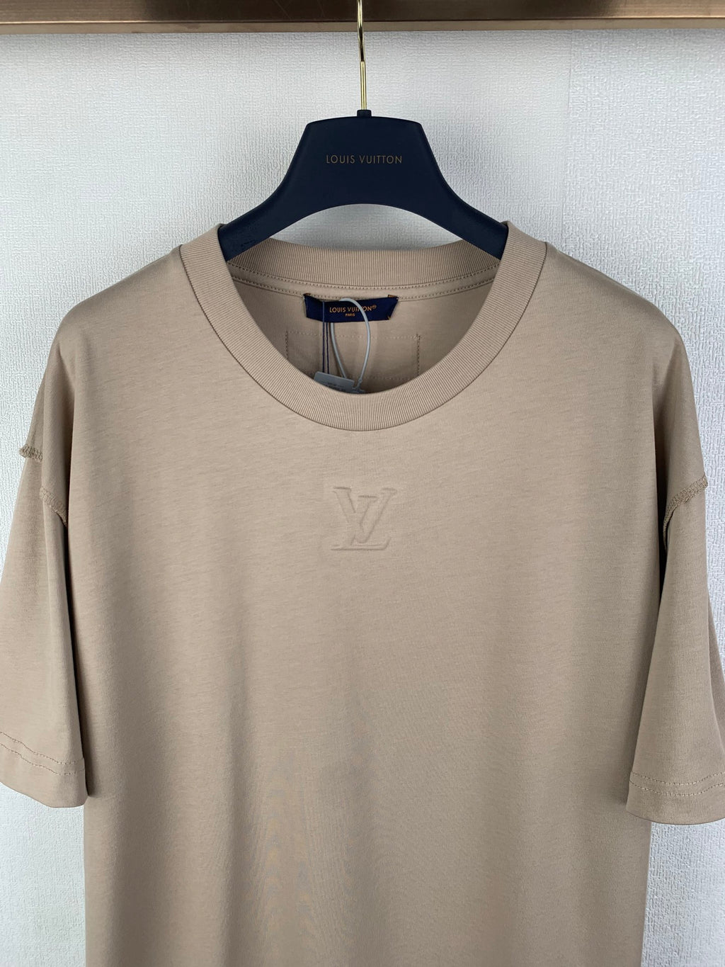 Louis Vuitton short-sleeve T-shirt, beige crew neck close-up with LV logo