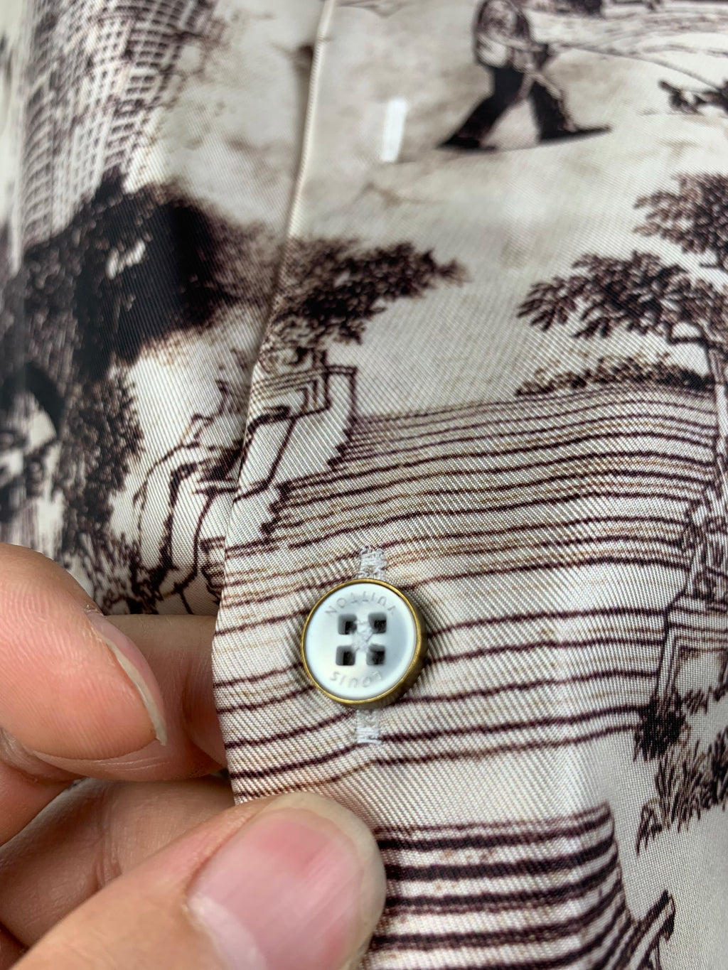 Long-sleeve shirt placket with round button and striped pattern