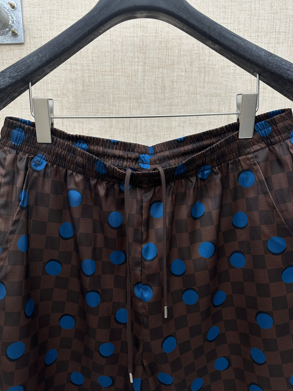 Brown shorts with elastic drawstring waist and blue dot and check print