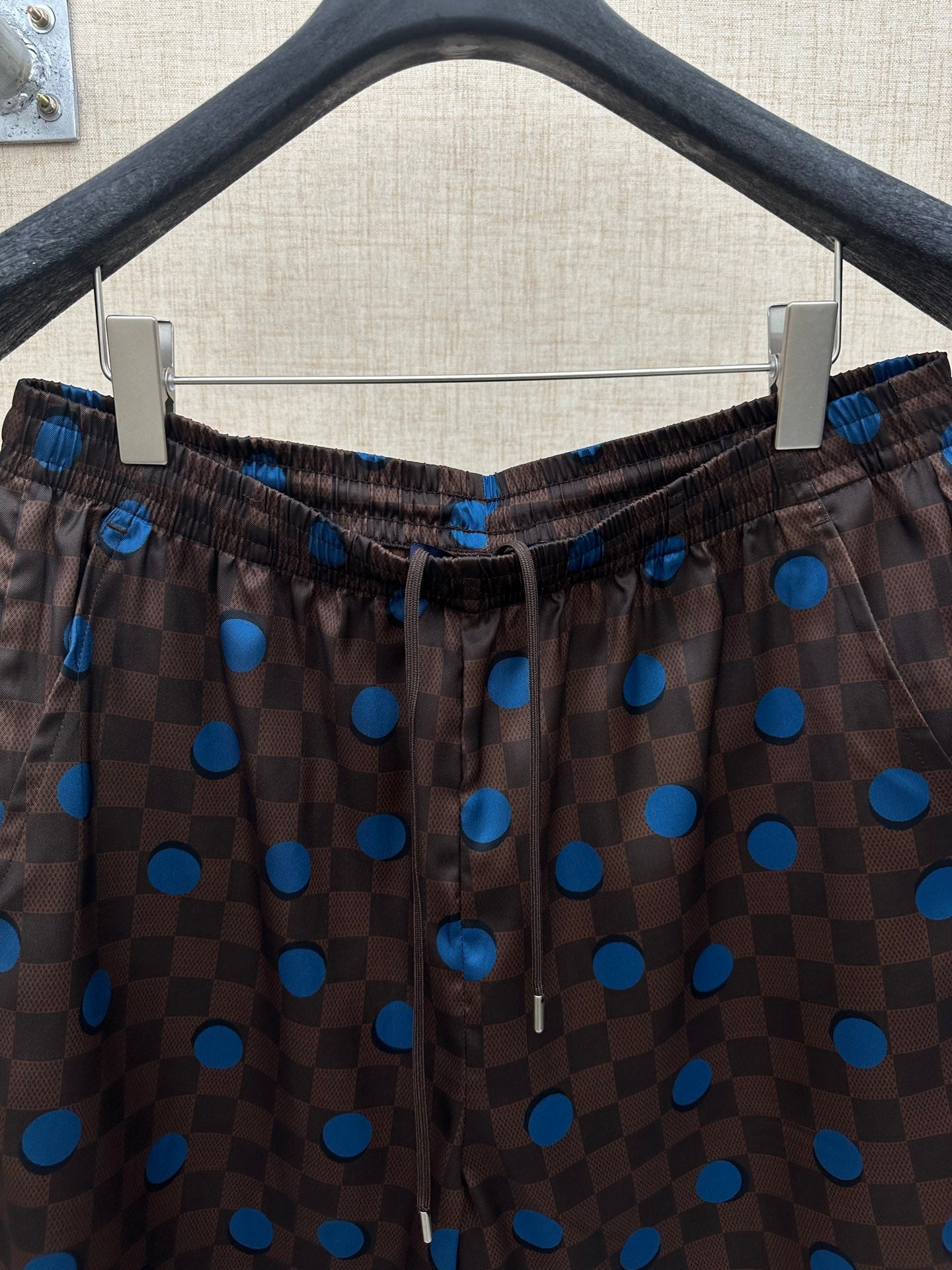 Brown shorts with elastic drawstring waist and blue dot and check print