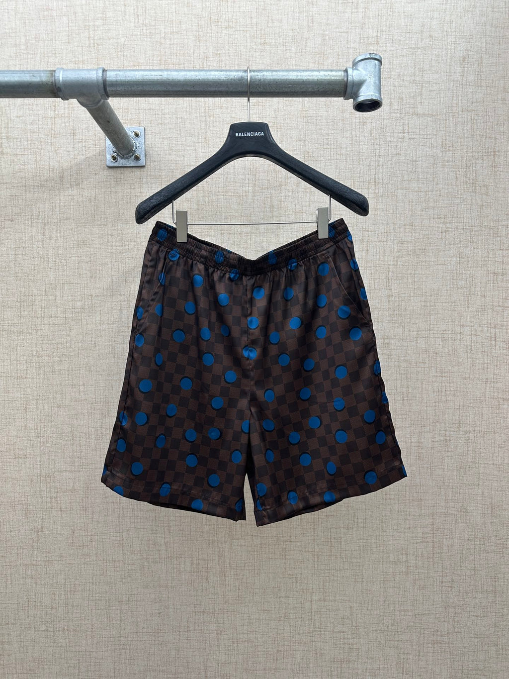 Brown shorts with elastic waistband and blue dot and check pattern