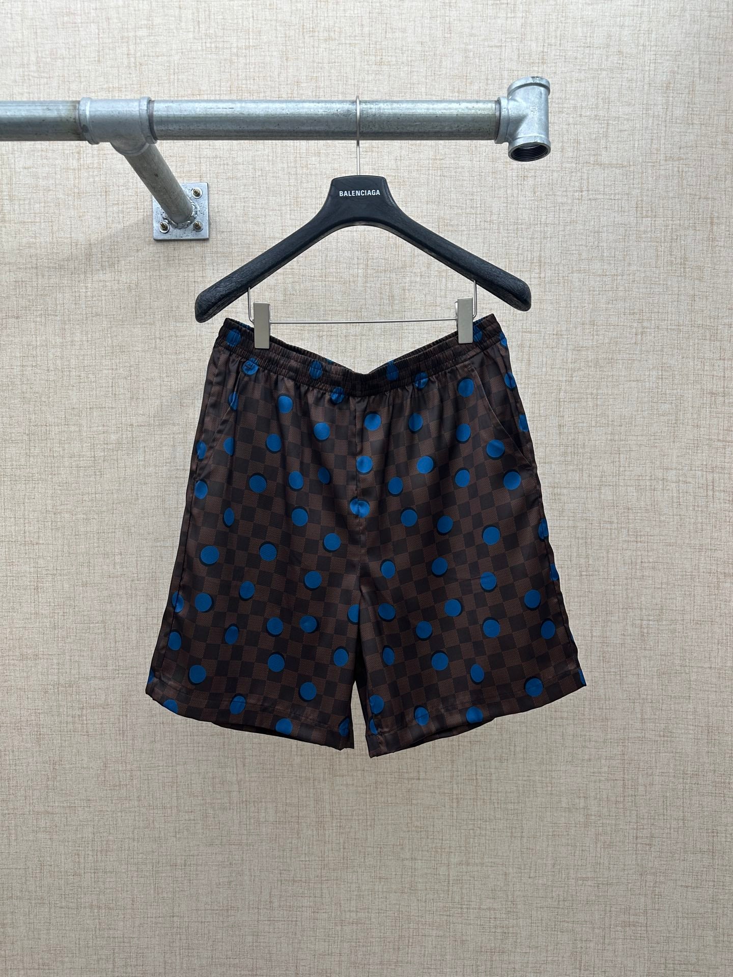 Brown shorts with elastic waistband and blue dot and check pattern