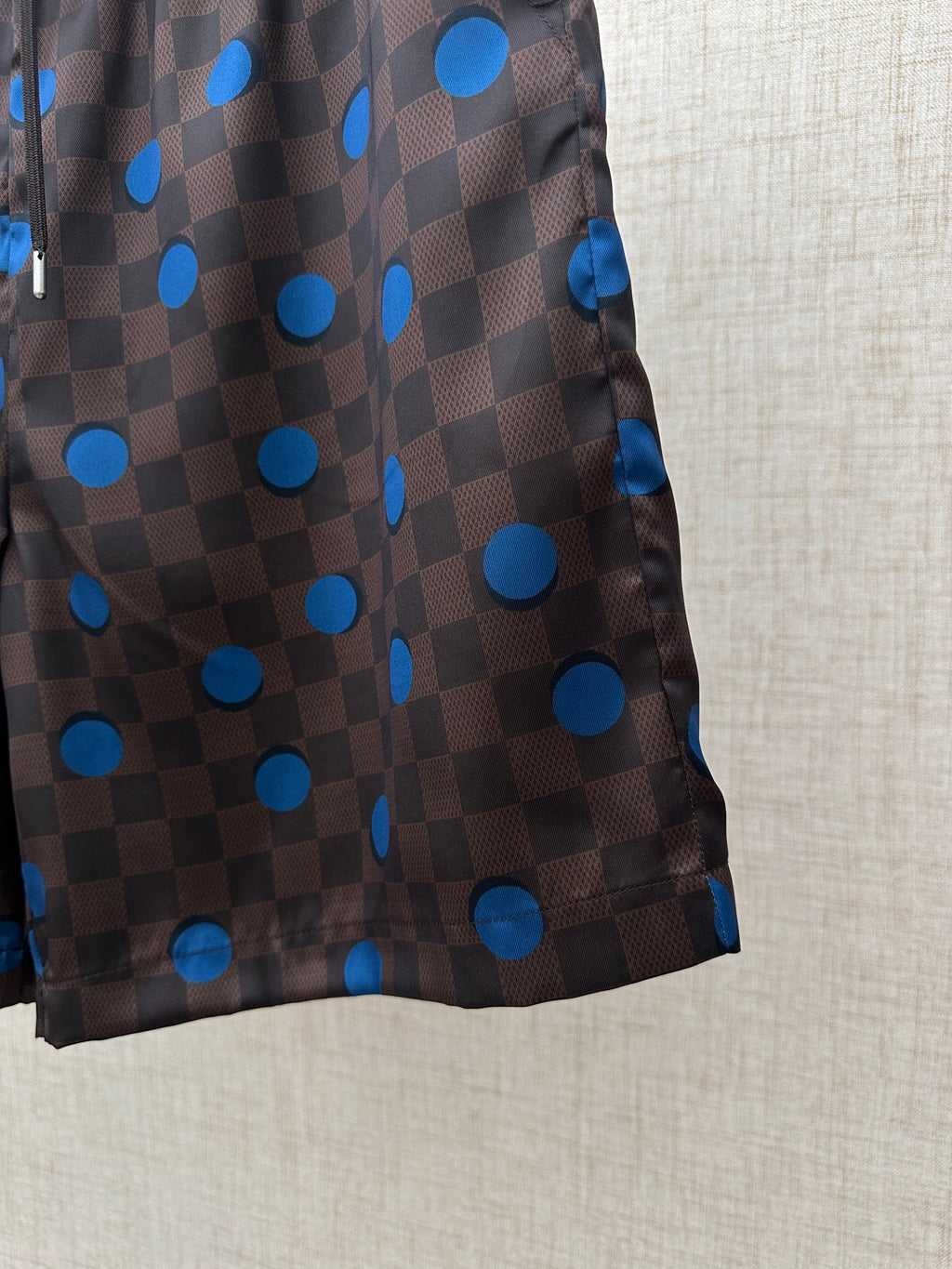 Brown shorts with blue polka-dot and check print, side view