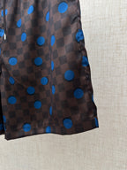 Brown shorts with blue polka-dot and check print, side view