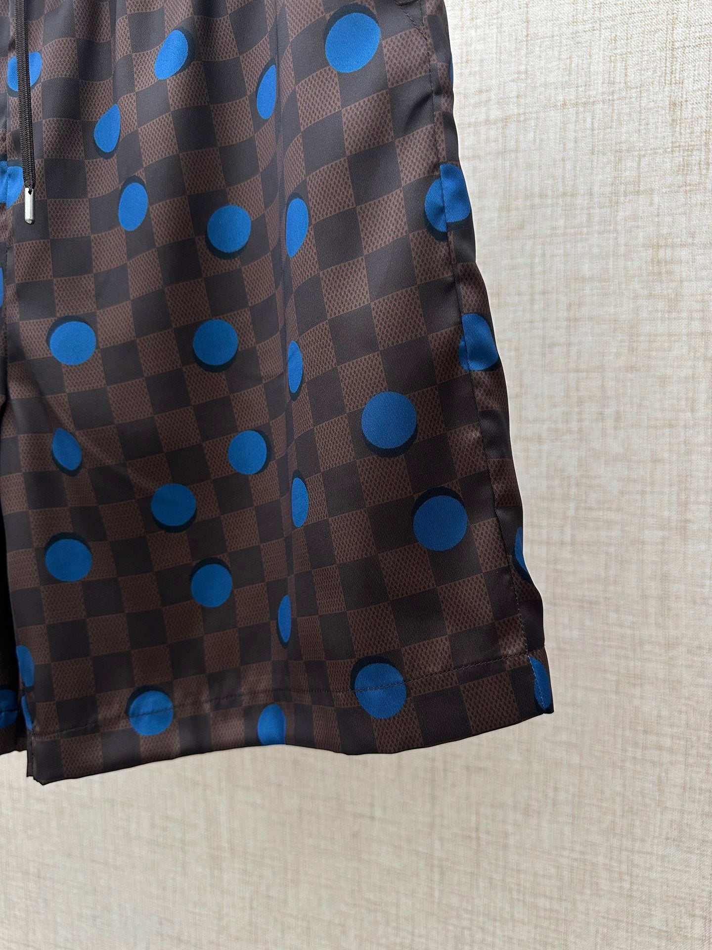 Brown shorts with blue polka-dot and check print, side view