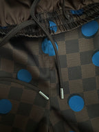 Brown drawstring shorts with blue polka-dot check pattern and metal aglets