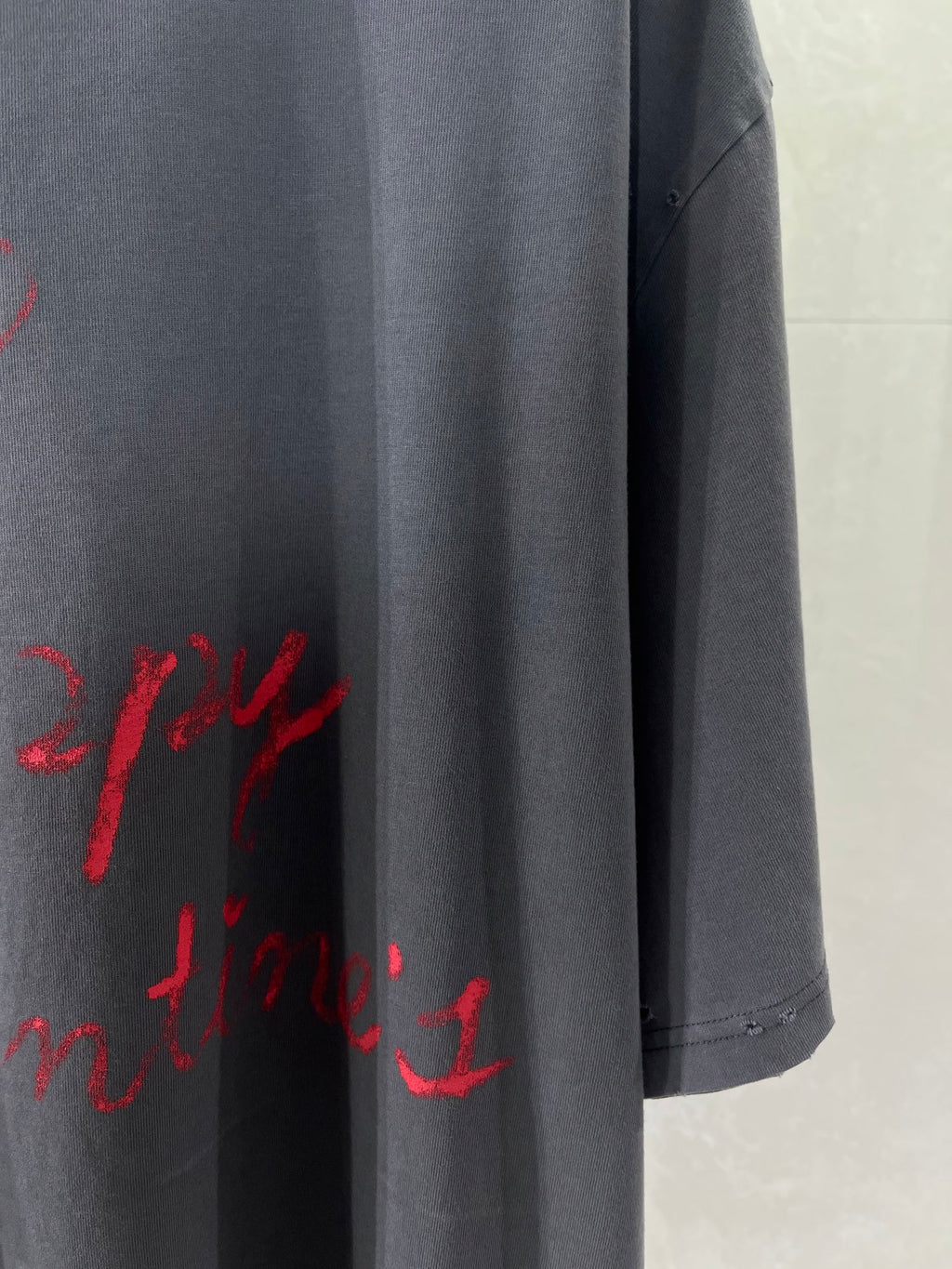 Balenciaga dark navy T-shirt hem and side seam with partial red script print