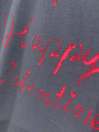 Balenciaga dark navy T-shirt fabric with red cursive script print close-up