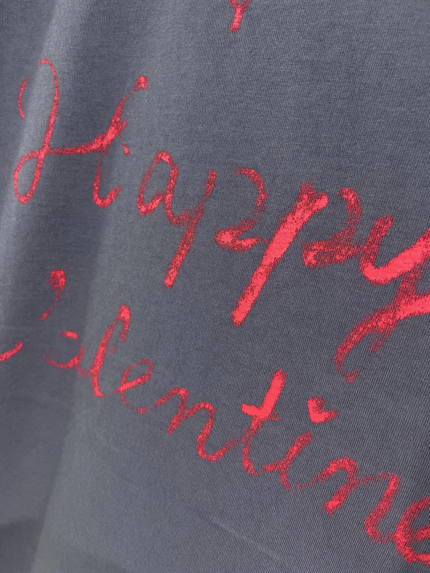 Balenciaga dark navy T-shirt fabric with red cursive script print close-up